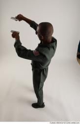 ERIC STANDING POSE WITH GUNS